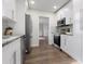 Well-lit kitchen features stainless steel appliances, white cabinets, and durable countertops for a modern look at 1105 Oakview Ave, Clearwater, FL 33756
