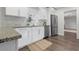 Modern kitchen features white cabinetry, stainless steel appliances, and granite countertops at 1105 Oakview Ave, Clearwater, FL 33756