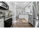 Modern kitchen with stainless steel appliances, white cabinets, and granite countertops at 1105 Oakview Ave, Clearwater, FL 33756