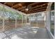 A screened-in porch with a fan, string lights, a wooden ceiling and decorative wooden lattice at 1105 Oakview Ave, Clearwater, FL 33756