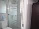Bathroom with white marble wall tiles and a glass door shower at 12400 Park Blvd # 111, Seminole, FL 33772