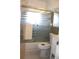 Bathroom with a shower with sliding doors, tiles and mirror at 12400 Park Blvd # 111, Seminole, FL 33772