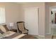 Bedroom with a chair and sliding door closet and view into another room at 12400 Park Blvd # 111, Seminole, FL 33772