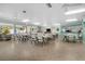 Bright clubhouse featuring tile flooring, seating areas, ceiling fans, and a small kitchen area at 12400 Park Blvd # 111, Seminole, FL 33772