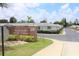 Seminole Hill Villas 55+ community entrance featuring a brick sign, landscaping, and well-maintained grounds at 12400 Park Blvd # 111, Seminole, FL 33772