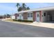 Attractive home featuring brick accents, a covered entry, manicured landscaping, and a carport at 12400 Park Blvd # 111, Seminole, FL 33772