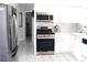 Modern kitchen features stainless steel appliances and bright white cabinetry at 12400 Park Blvd # 111, Seminole, FL 33772