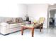 Inviting living room with comfortable seating, lamps, marble floors, and access to bedroom at 12400 Park Blvd # 111, Seminole, FL 33772