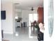 Spacious living room open to dining area features modern tile floors and bright lighting at 12400 Park Blvd # 111, Seminole, FL 33772