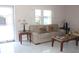 Bright living room features a leather sofa, lamps, and sleek marble floors at 12400 Park Blvd # 111, Seminole, FL 33772