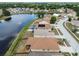 Aerial view of a neighborhood with a pond, highlighting various home styles and community layout at 12531 Midpointe Dr, Riverview, FL 33578
