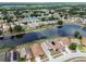 Community aerial view highlighting homes with lake access, solar panels and well-maintained landscaping at 12531 Midpointe Dr, Riverview, FL 33578