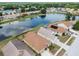Overhead view of homes situated alongside a pond, surrounded by lush trees and landscaping at 12531 Midpointe Dr, Riverview, FL 33578