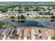 Scenic aerial of community homes with backyards along a lake, some featuring solar panels at 12531 Midpointe Dr, Riverview, FL 33578