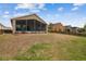 Large backyard with a screened lanai, offering a private outdoor living space at 12531 Midpointe Dr, Riverview, FL 33578