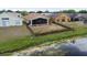 Aerial view of a fenced backyard with screened-in patio, with view of the pond at 12531 Midpointe Dr, Riverview, FL 33578