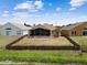 Aerial view of a fenced backyard with screened-in patio at 12531 Midpointe Dr, Riverview, FL 33578