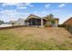 Back of the house with a screened-in lanai, backyard, and fencing at 12531 Midpointe Dr, Riverview, FL 33578