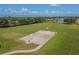 Outdoor basketball court situated in a community park with ample green space and trees at 12531 Midpointe Dr, Riverview, FL 33578
