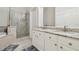 Bathroom featuring double sinks, granite countertops, and a glass shower at 12531 Midpointe Dr, Riverview, FL 33578