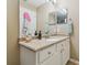 Well lit bathroom with a large mirror and vanity, offering plenty of space for personal grooming and storage at 12531 Midpointe Dr, Riverview, FL 33578