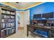 Bright bedroom with custom blue paint, desk workstation, and bookcase at 12531 Midpointe Dr, Riverview, FL 33578