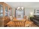 Well-lit dining room with a large wooden table, cabinet, and chandelier at 12531 Midpointe Dr, Riverview, FL 33578