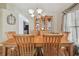 Traditional dining room with wood table set, china cabinet, and elegant chandelier at 12531 Midpointe Dr, Riverview, FL 33578