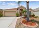 Charming single-story home with landscaped front yard and attached two-car garage at 12531 Midpointe Dr, Riverview, FL 33578