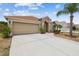 Well-maintained single-story home featuring a spacious driveway and manicured landscaping at 12531 Midpointe Dr, Riverview, FL 33578