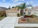 Inviting home featuring a spacious driveway, manicured landscaping, and a cozy entrance at 12531 Midpointe Dr, Riverview, FL 33578