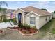 Well-maintained home with lush landscaping, charming entryway, and a spacious two-car garage at 12531 Midpointe Dr, Riverview, FL 33578