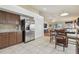 Bright kitchen and dining with stainless steel appliances, tile flooring, and lots of cabinets at 12531 Midpointe Dr, Riverview, FL 33578