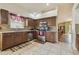 Fully equipped kitchen featuring stainless appliances, mosaic backsplash, and smooth tile flooring at 12531 Midpointe Dr, Riverview, FL 33578
