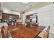 Large dining table with seating for four and views of kitchen with stainless steel appliances at 12531 Midpointe Dr, Riverview, FL 33578