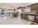 Open kitchen and dining area with stainless steel appliances, tile floors, and window views to living space at 12531 Midpointe Dr, Riverview, FL 33578