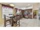 Bright kitchen with stainless appliances, dark wood cabinets, tile floors, and adjacent dining area at 12531 Midpointe Dr, Riverview, FL 33578