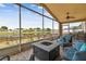 Beautiful lake view from the screened lanai with fire pit and outdoor seating at 12531 Midpointe Dr, Riverview, FL 33578
