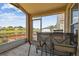 Enclosed lanai with a table and chairs overlooking the lake at 12531 Midpointe Dr, Riverview, FL 33578