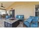 A well-appointed lanai featuring comfortable seating and a fire pit table at 12531 Midpointe Dr, Riverview, FL 33578