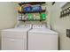 Laundry room featuring a side-by-side washer and dryer and storage shelves at 12531 Midpointe Dr, Riverview, FL 33578