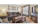 Cozy living room featuring a comfortable sofa, fireplace, and modern decor at 12531 Midpointe Dr, Riverview, FL 33578
