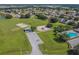 Aerial view of a community park featuring a playground, basketball court, and parking lot at 12531 Midpointe Dr, Riverview, FL 33578