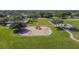 Bright playground with swings and slides, located in a beautiful green community park area at 12531 Midpointe Dr, Riverview, FL 33578
