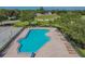 Aerial view of a community pool and sun deck, surrounded by lush landscaping and lawn chairs at 12531 Midpointe Dr, Riverview, FL 33578