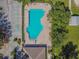 Aerial view of a community pool, sundeck, parking area and meticulously maintained landscaping at 12531 Midpointe Dr, Riverview, FL 33578