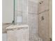 Walk-in shower with neutral tile and pebble floor at 12531 Midpointe Dr, Riverview, FL 33578