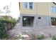Exterior view of backyard with sliding glass door access and partially fenced yard at 1311 S Moody Ave # 1, Tampa, FL 33629
