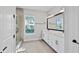 Elegant bathroom features a dual vanity, quartz countertop, framed mirror, and a glass-enclosed shower at 1311 S Moody Ave # 1, Tampa, FL 33629