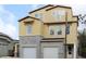 A newly constructed, two-story home with yellow siding and a two-car garage under blue skies at 1311 S Moody Ave # 1, Tampa, FL 33629